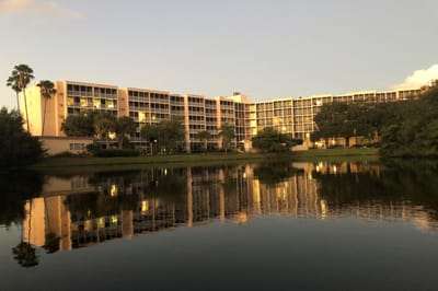 Exterior view of Sun Towers Retirement Community by a lake