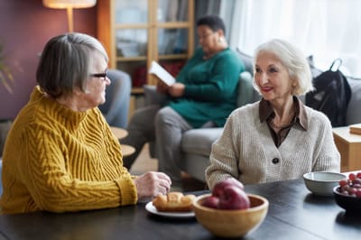 Residents chatting with food on the table