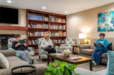 Residents reading in a cozy common area
