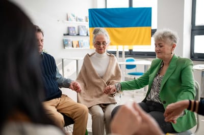 Residents participating in a group activity in a bright room