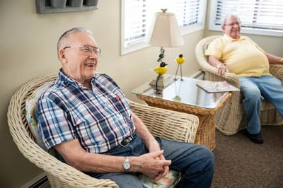Two residents sitting in a common area