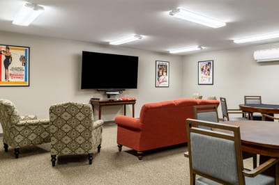 Interior common area with seating and a large TV