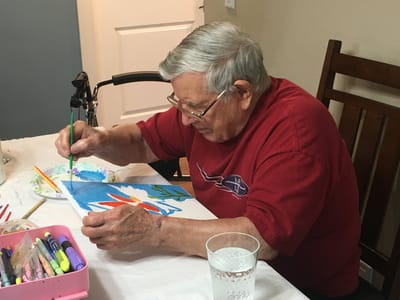 Resident painting during an art activity