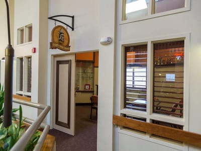 Common area with seating and entry to different rooms