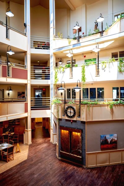 Bright interior common area with seating and fireplace