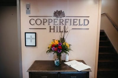 Indoor entrance area with flowers and facility signage