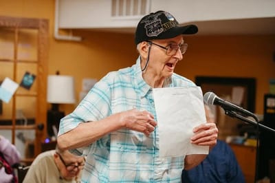 Resident engaged in an activity at a microphone