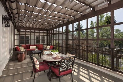 Outdoor patio area with seating and greenery