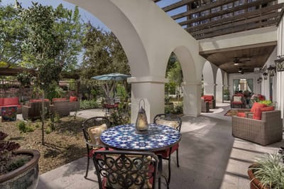 Beautiful outdoor seating area with table and greenery