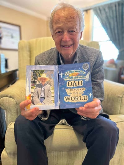Resident showcasing a heartfelt card with a photo