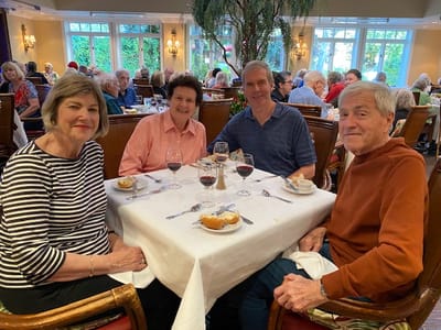 Residents enjoying dinner together at a dining table