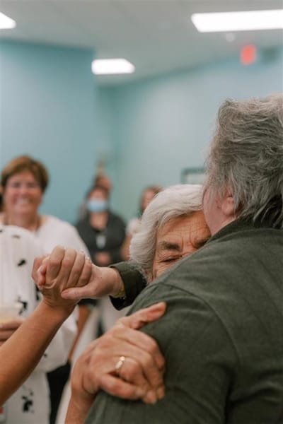 Residents enjoying a warm embrace in a common area