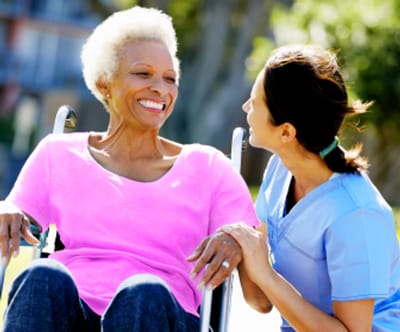 Resident and caregiver enjoying an outdoor moment