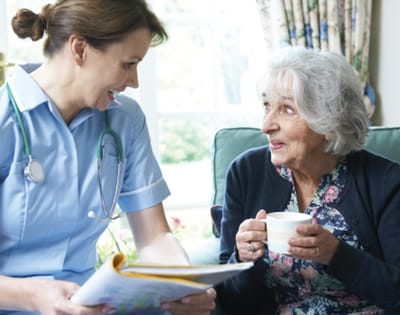 Nurse interacting with a resident in a cozy setting
