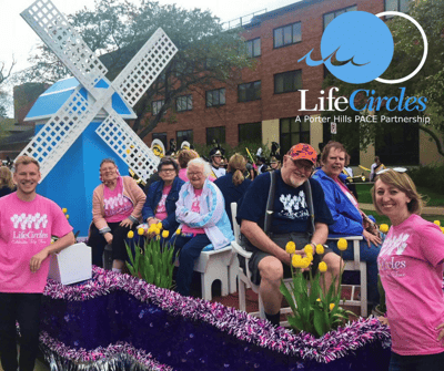 Residents enjoying a community event with flowers and decorations