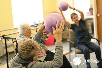 Residents participating in an exercise activity with balls