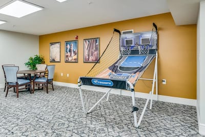 Common area with a basketball arcade game and seating