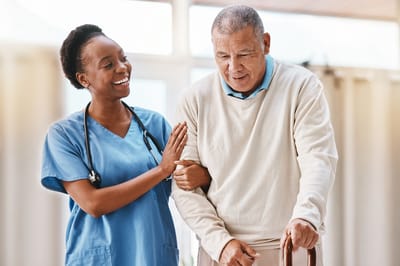 A nurse assisting a senior resident indoors