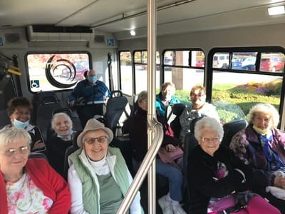 Residents enjoying a ride in the facility's transport bus
