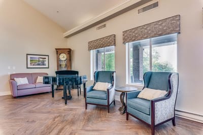 Bright common area with seating and a clock
