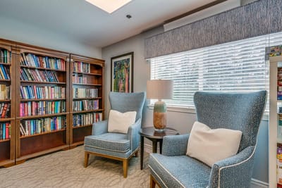 Cozy reading area with bookshelves and chairs