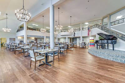 Dining room setup with tables and chandeliers
