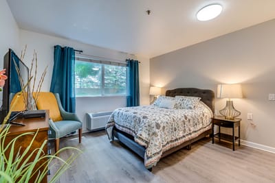 Cozy resident room with a bed and seating area