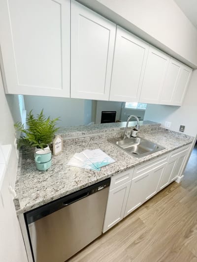 Modern kitchen area with countertop and appliances