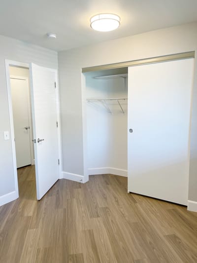 Empty resident room with closet and door