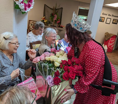 Residents enjoying a floral celebration in a common area