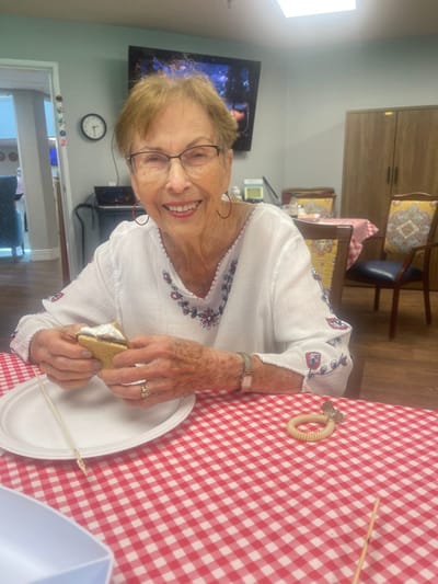 A resident enjoying a snack in a dining area