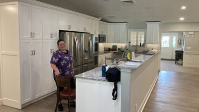 A staff member smiling in a modern kitchen