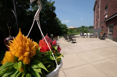 Patio space with hanging flowers and seating area