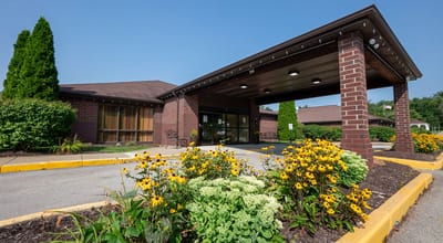 Exterior view with flowers at Loyalhanna Senior Suites