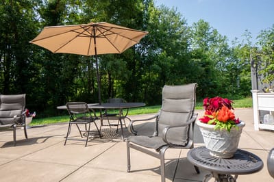 Patio area with tables and flowers in a garden setting