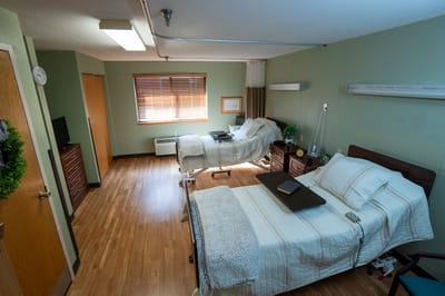 A shared resident room with two beds and furnishings
