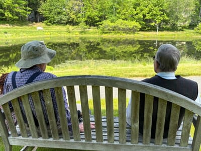 Two residents enjoying a peaceful view by the pond