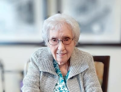 Smiling resident in a cozy indoor setting