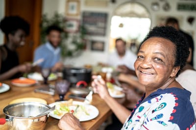 Residents enjoying a meal together at a dining table