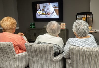 Residents enjoying a movie in a common area