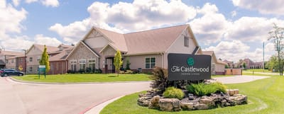 Exterior view of The Castlewood Senior Living with signage