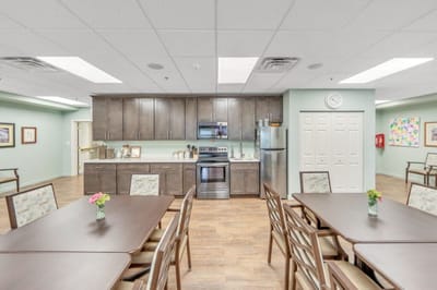 Dining area with tables and kitchen appliances