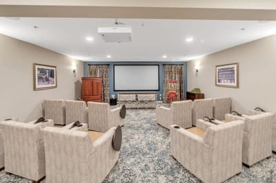 Comfortable common area with seating and a projector
