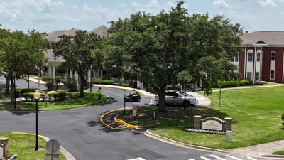 Exterior view of the facility with landscaping and vehicles
