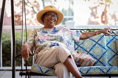 Resident relaxing on a swing in a common area