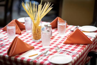 Dining table set with spaghetti centerpiece