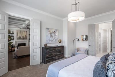 Brightly lit bedroom with modern decor and open doors