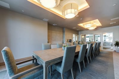 Elegant dining room with a long table and modern lighting