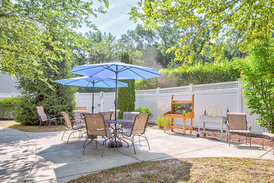 Outdoor seating area with umbrellas and a garden