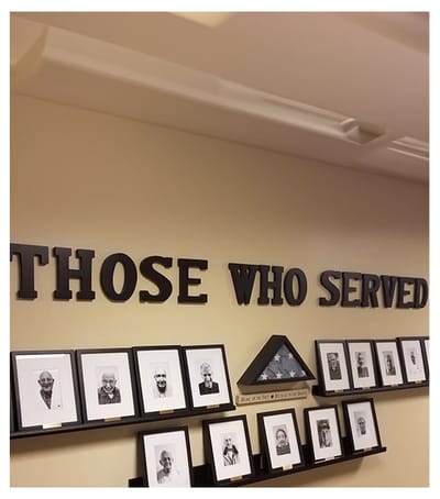 Wall display honoring veterans with portraits